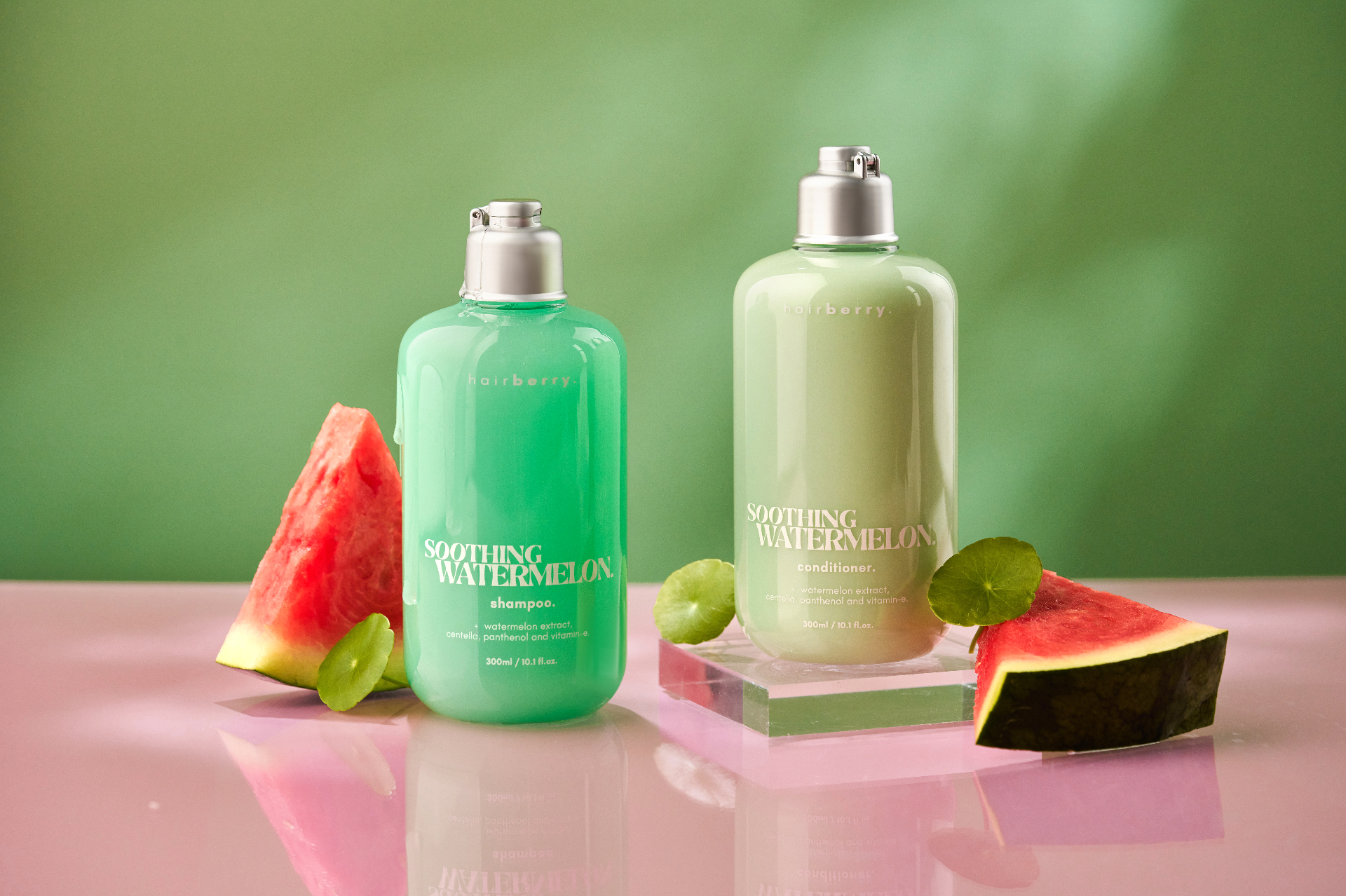 Hairberry products on glass pedestals with green backdrop